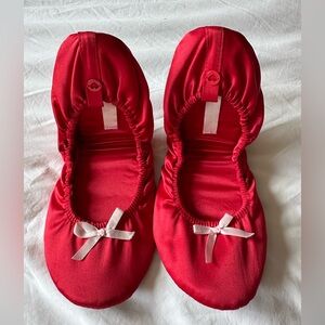 Red slippers with white bows
